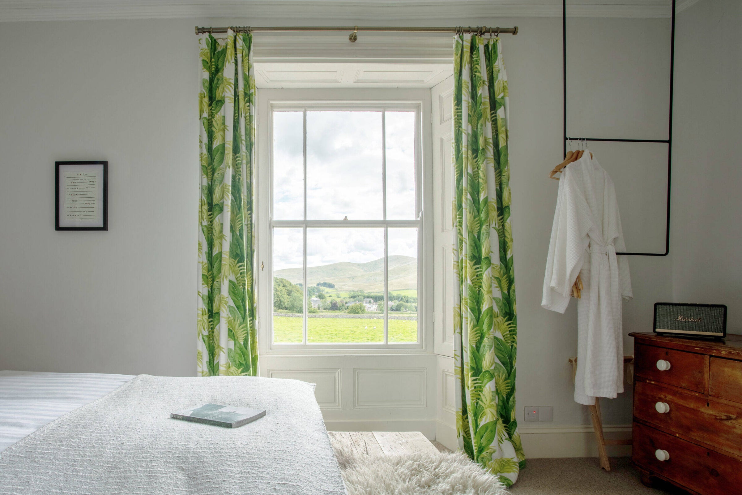 A bedroom at Brownber Hall, with a window looking out towards the surrounding countryside